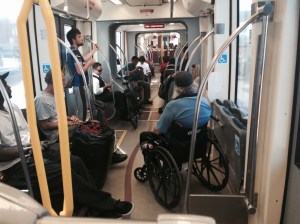 Our streetcar will work like this-1. bikes roll on and owners control them (see bike in middle of picture)- 2. wheelchairs roll on, find their designated location and LOCK WHEELS (no tie down). Picture from San Diego Trolley (light rail)